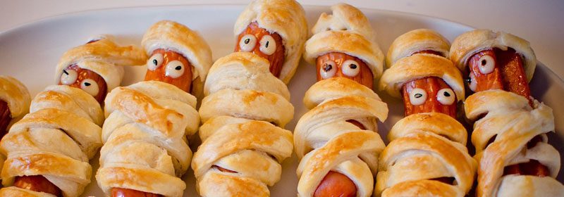 Sausages on a plate beside a laptop, symbolising local IT support for financial services.